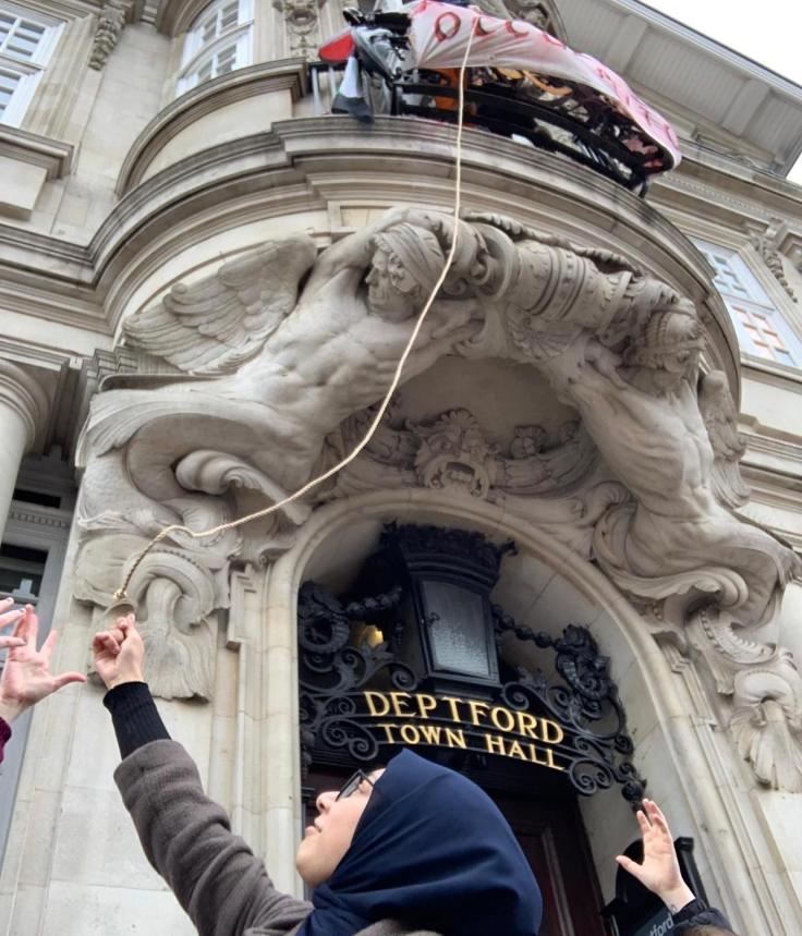 Photograph of students unfurling GARA banner on the front of Deptford Town Hall.
